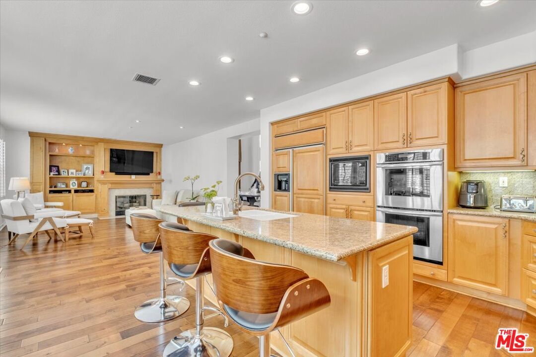 Dining room, Fireplace, Interior, Kitchen, Living room, Recessed Lighting, Stainless Steel Appliances, Wood Texture Flooring
