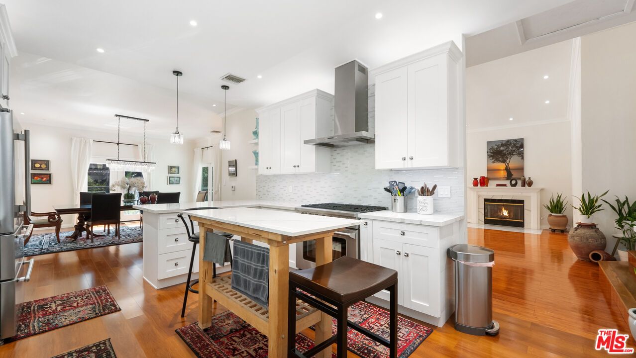 Dining room, Fireplace, Interior, Kitchen, Pendant Lights, Recessed Lighting, Stainless Steel Appliances, Wood Texture Flooring