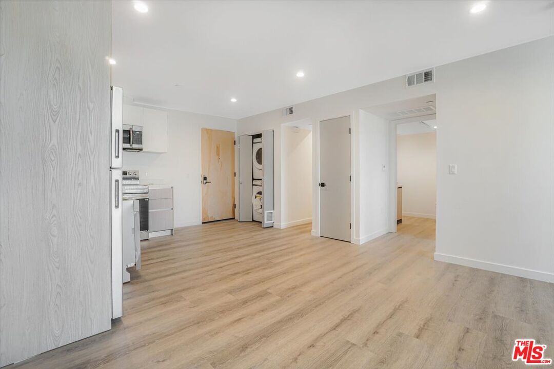 Empty room, Interior, Kitchen, Recessed Lighting, Stainless Steel Appliances, Wood Texture Flooring