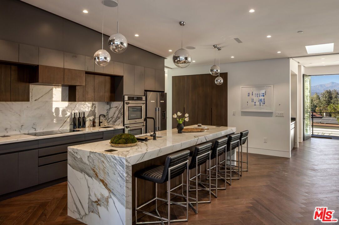 Interior, Kitchen, Marble Walls, Pendant Lights, Recessed Lighting, Stainless Steel Appliances, Wood Texture Flooring