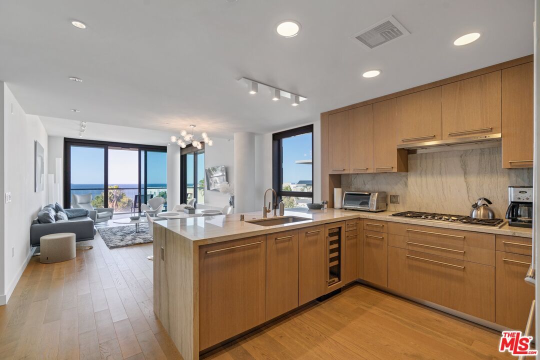 Dining room, Interior, Kitchen, Living room, Recessed Lighting, Stainless Steel Appliances, Water, Wood Texture Flooring