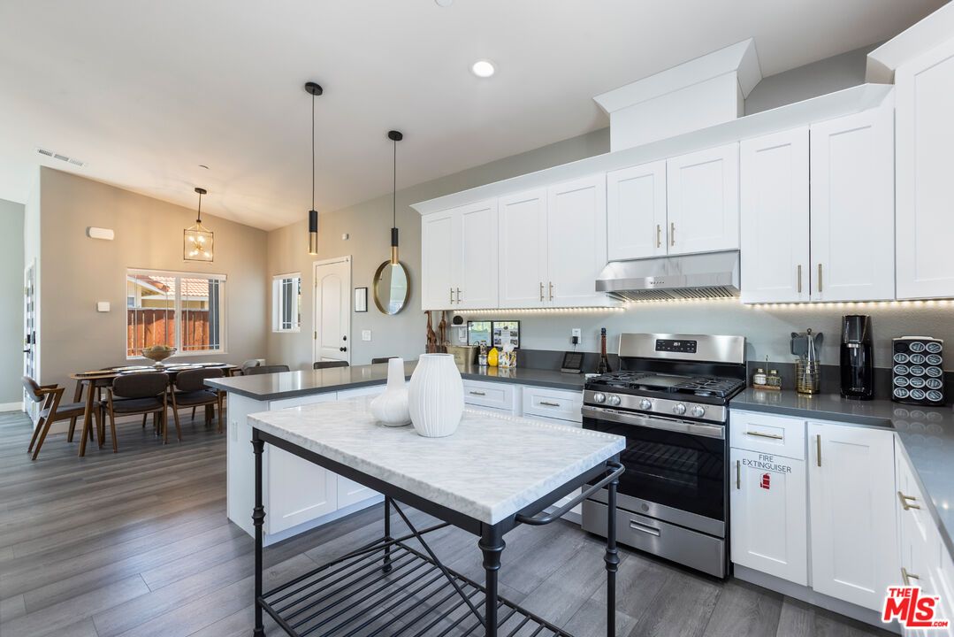 Dining room, Interior, Kitchen, Pendant Lights, Recessed Lighting, Stainless Steel Appliances, Wood Texture Flooring