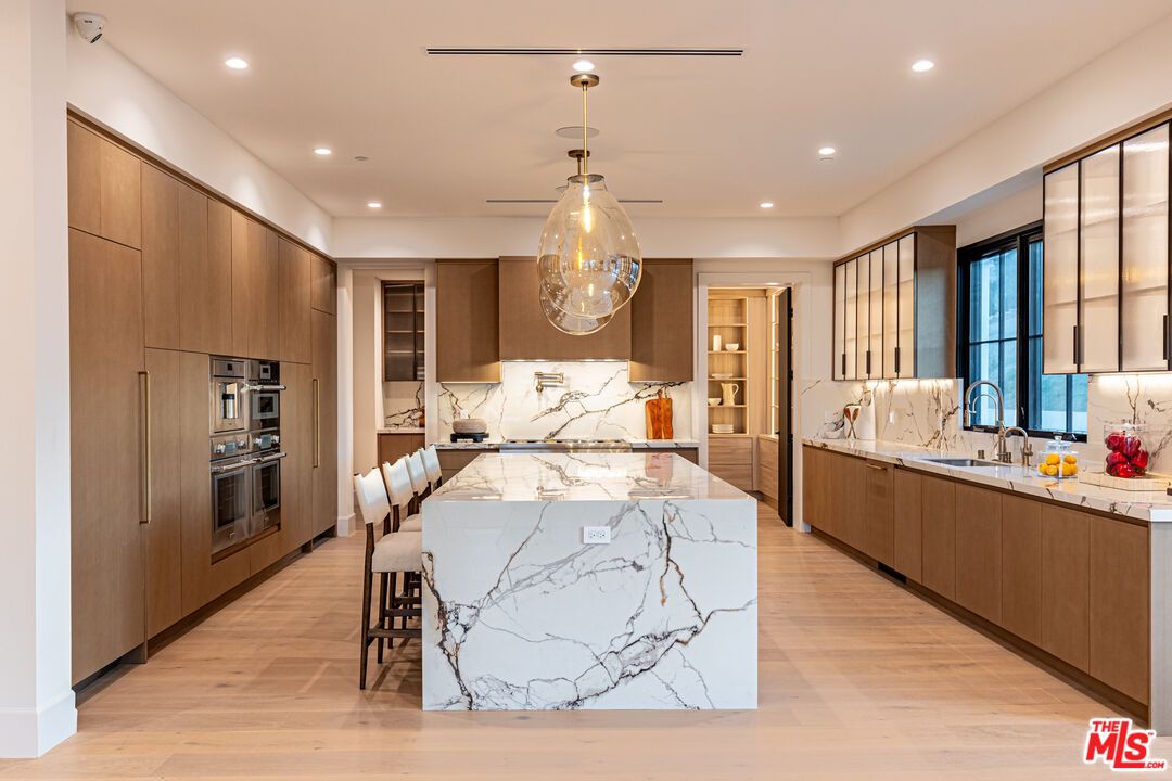 Interior, Kitchen, Marble Walls, Pendant Lights, Recessed Lighting, Stainless Steel Appliances, Wood Texture Flooring