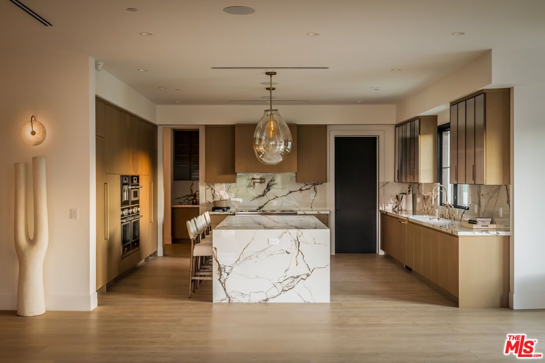 Interior, Kitchen, Marble Walls, Pendant Lights, Recessed Lighting, Stainless Steel Appliances, Wood Texture Flooring