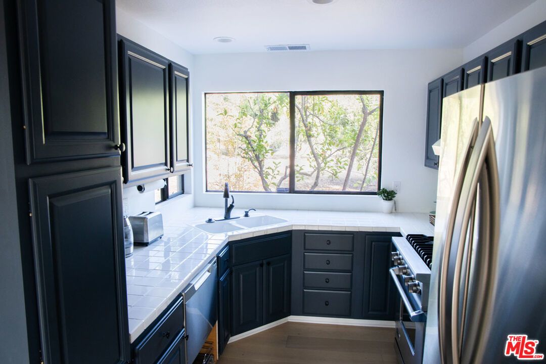 Interior, Kitchen, Recessed Lighting, Stainless Steel Appliances, Tile Countertops, Wood Texture Flooring