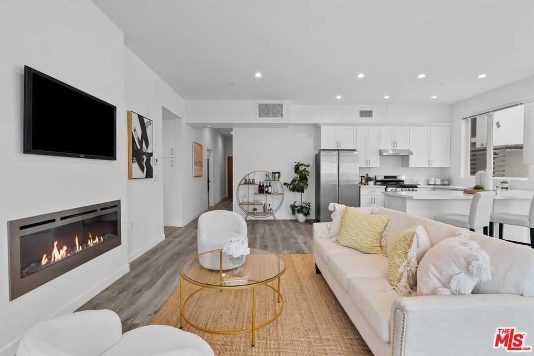 Dining room, Fireplace, Interior, Kitchen, Living room, Recessed Lighting, Stainless Steel Appliances, Wood Texture Flooring