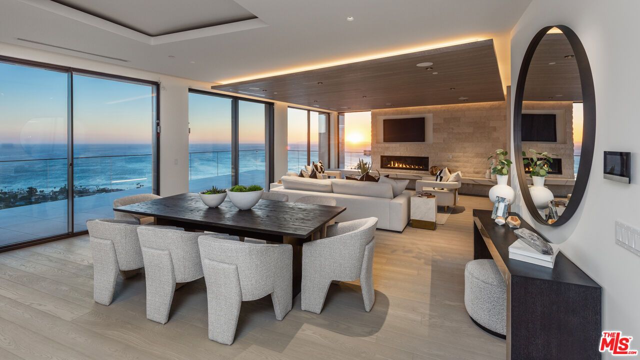Dining room, Fireplace, Interior, Living room, Recessed Lighting, Stone Walls, Water, Wood Texture Flooring