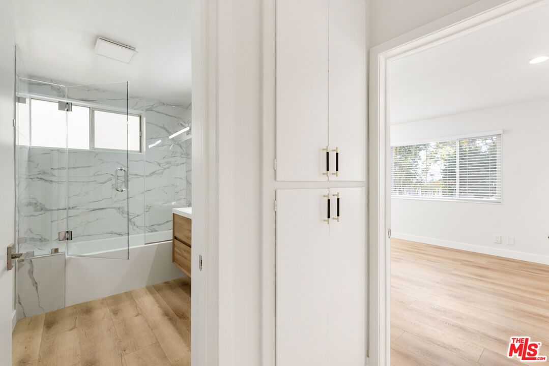 Bathroom, Glass Shower, Interior, Marble Walls, Recessed Lighting, Wood Texture Flooring