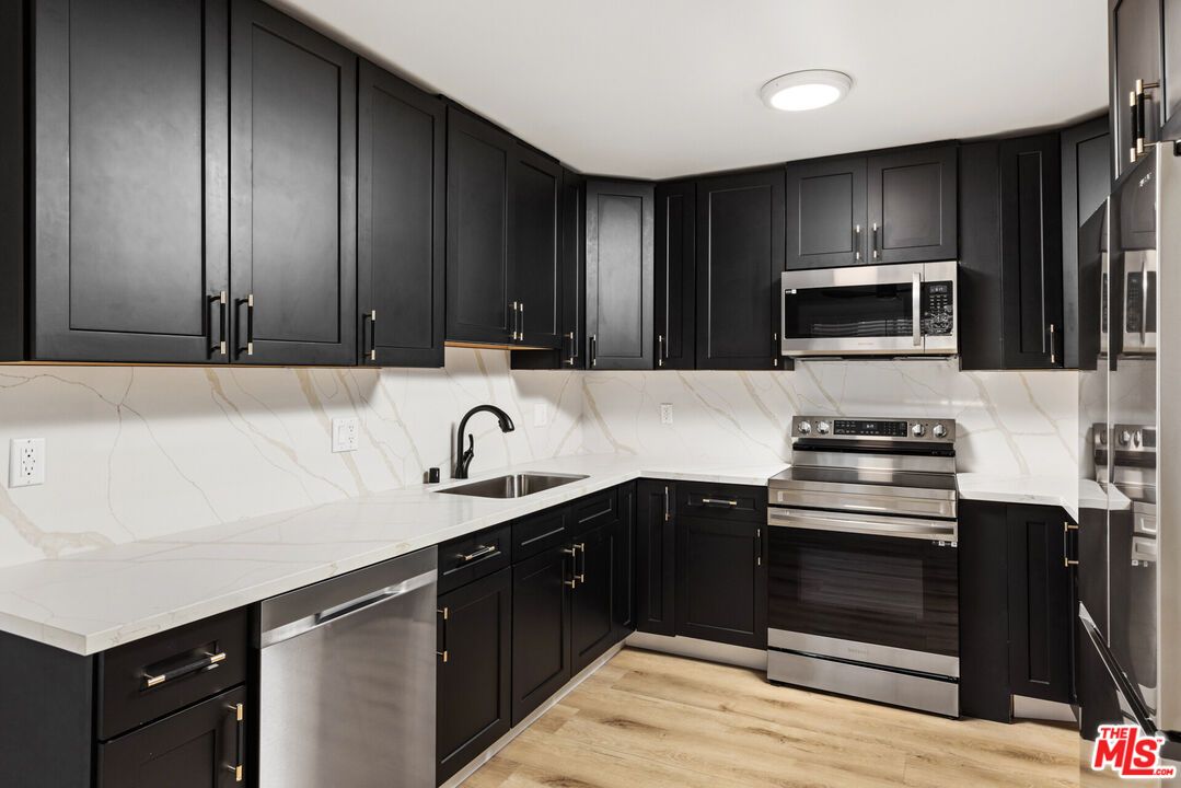 Interior, Kitchen, Marble Walls, Recessed Lighting, Stainless Steel Appliances, Wood Texture Flooring
