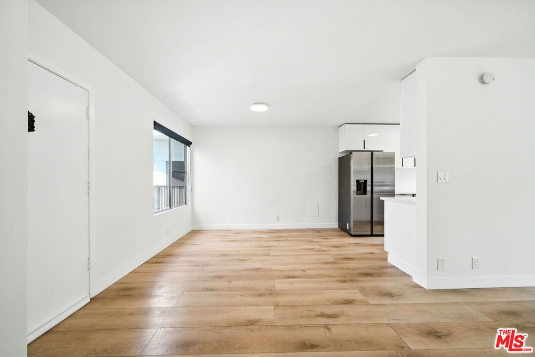 Empty room, Interior, Kitchen, Recessed Lighting, Stainless Steel Appliances, Wood Texture Flooring