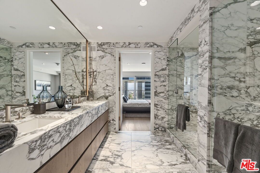 Bathroom, Dual Sink Vanities, Glass Shower, Interior, Marble, Marble Walls, Recessed Lighting, Wood Texture Flooring