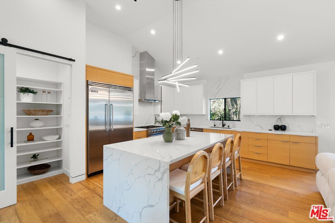 Interior, Kitchen, Marble Walls, Pendant Lights, Recessed Lighting, Stainless Steel Appliances, Wood Texture Flooring