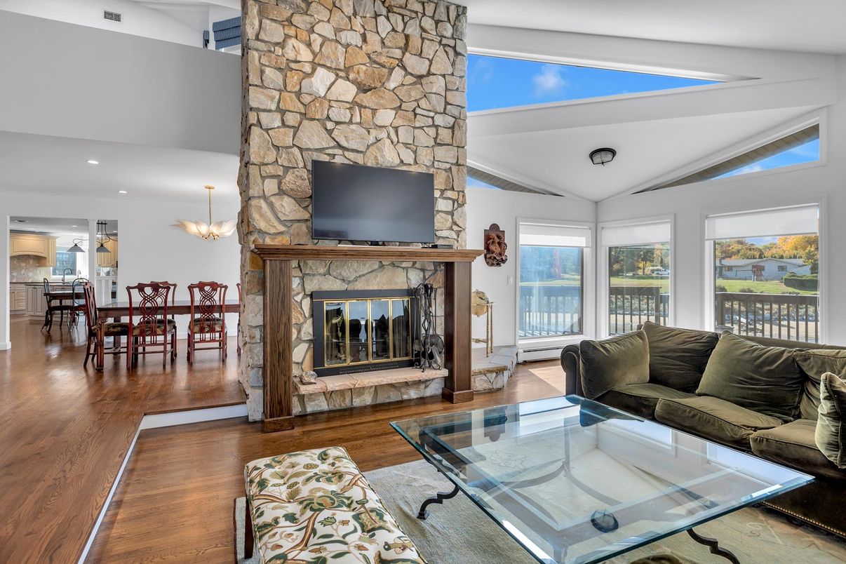 Chandelier, Dining room, Fireplace, Interior, Living room, Recessed Lighting, Stone Walls, Wood Texture Flooring