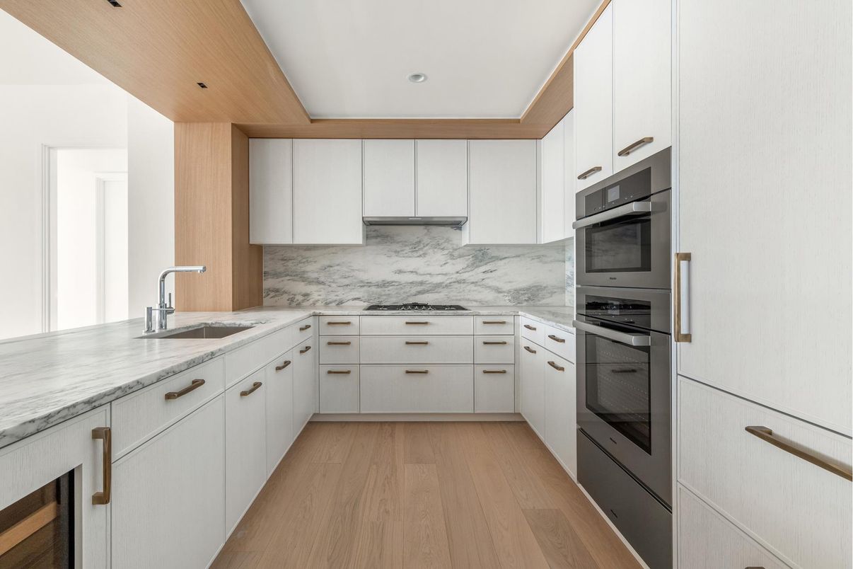 Interior, Kitchen, Marble Walls, Recessed Lighting, Stainless Steel Appliances, Wood Texture Flooring