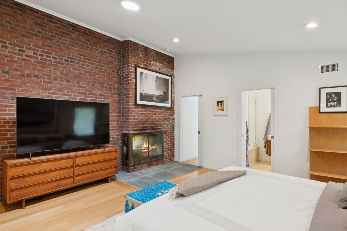 Bedroom, Fireplace, Interior, Recessed Lighting, Stone Walls, Wood Texture Flooring