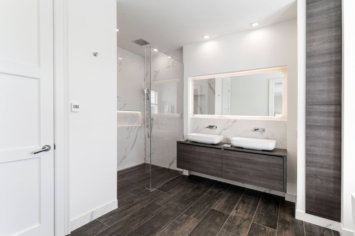 Bathroom, Dual Sink Vanities, Glass Shower, Interior, Marble Walls, Recessed Lighting, Wood Texture Flooring