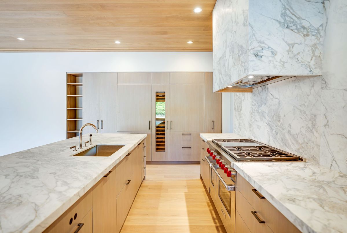 Interior, Kitchen, Marble Walls, Recessed Lighting, Stainless Steel Appliances, Wood Texture Flooring