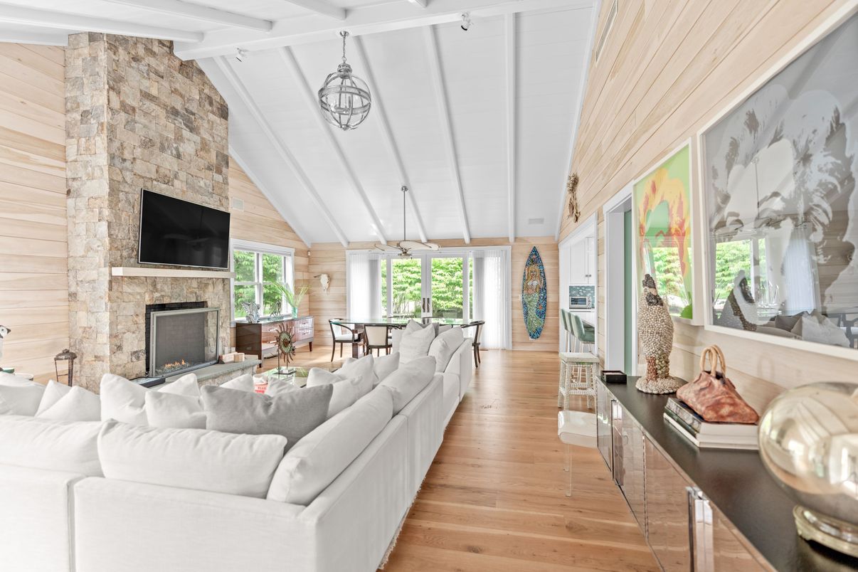 Chandelier, Dining room, Fireplace, Interior, Living room, Pendant Lights, Stone Walls, Wood Texture Flooring