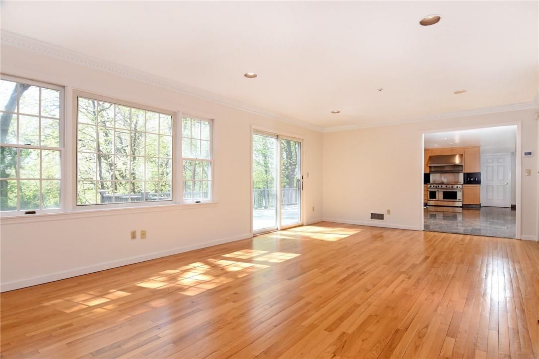 Empty room, Interior, Kitchen, Recessed Lighting, Stainless Steel Appliances, Wood Texture Flooring