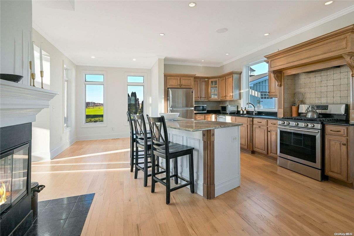 Fireplace, Interior, Kitchen, Recessed Lighting, Stainless Steel Appliances, Wood Texture Flooring