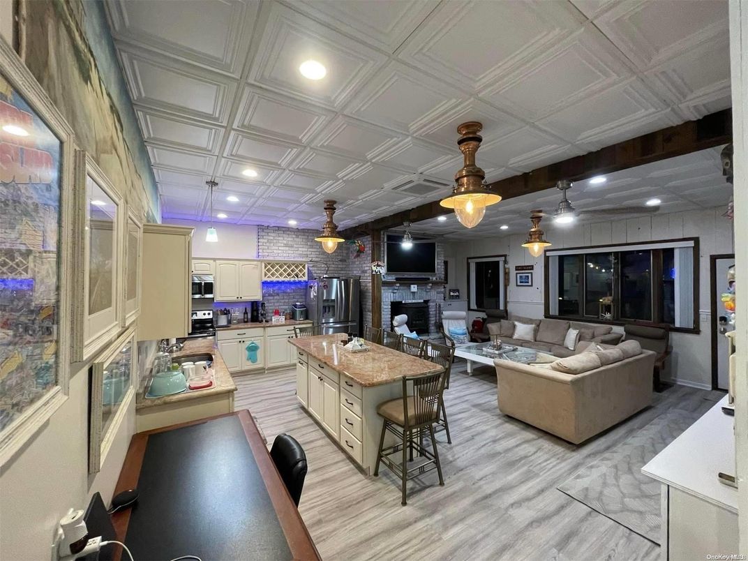 Fireplace, Interior, Kitchen, Living room, Pendant Lights, Recessed Lighting, Stainless Steel Appliances, Stone Walls, Wood Texture Flooring