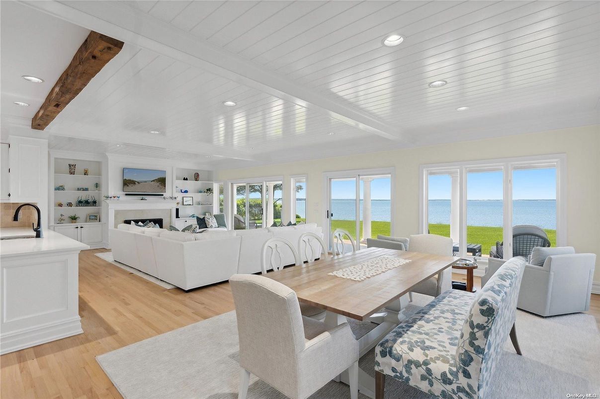 Dining room, Fireplace, Interior, Living room, Recessed Lighting, Water, Wooden Beams, Wood Texture Flooring