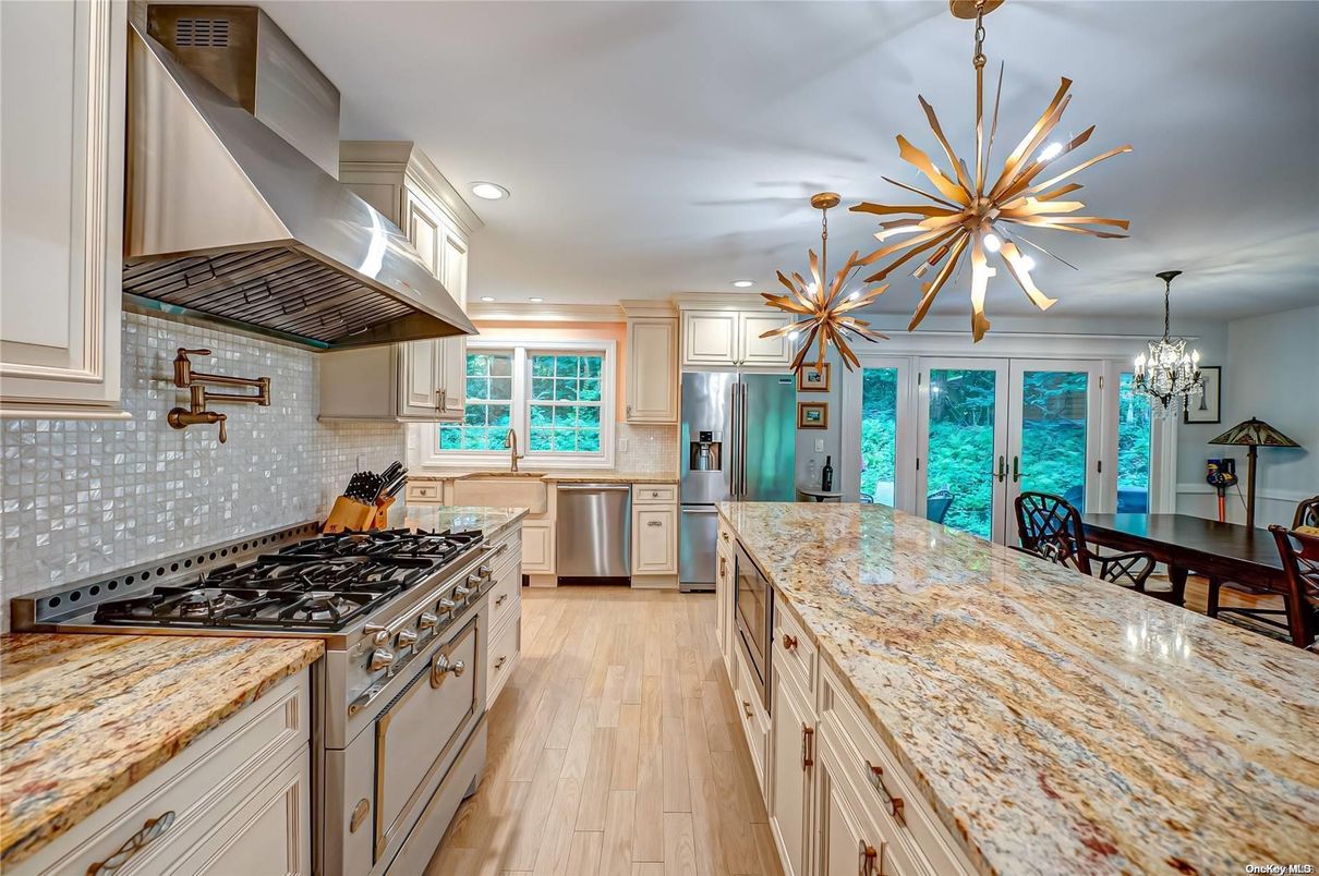 Chandelier, Dining room, Interior, Kitchen, Pendant Lights, Recessed Lighting, Stainless Steel Appliances, Wood Texture Flooring