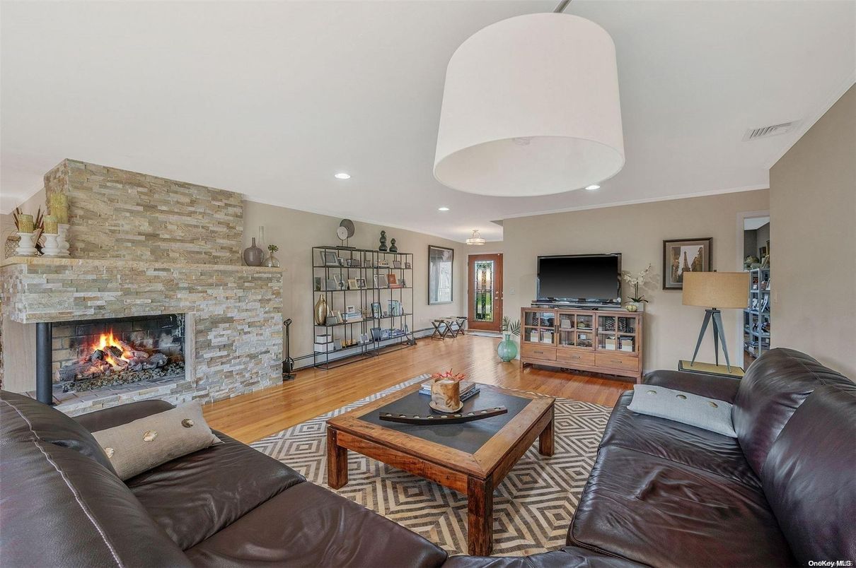 Fireplace, Interior, Living room, Recessed Lighting, Stone Walls, Wood Texture Flooring