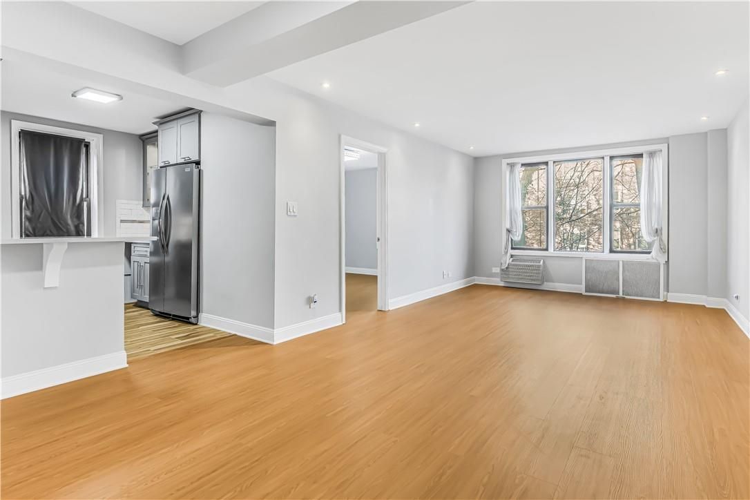 Empty room, Interior, Kitchen, Recessed Lighting, Stainless Steel Appliances, Wood Texture Flooring