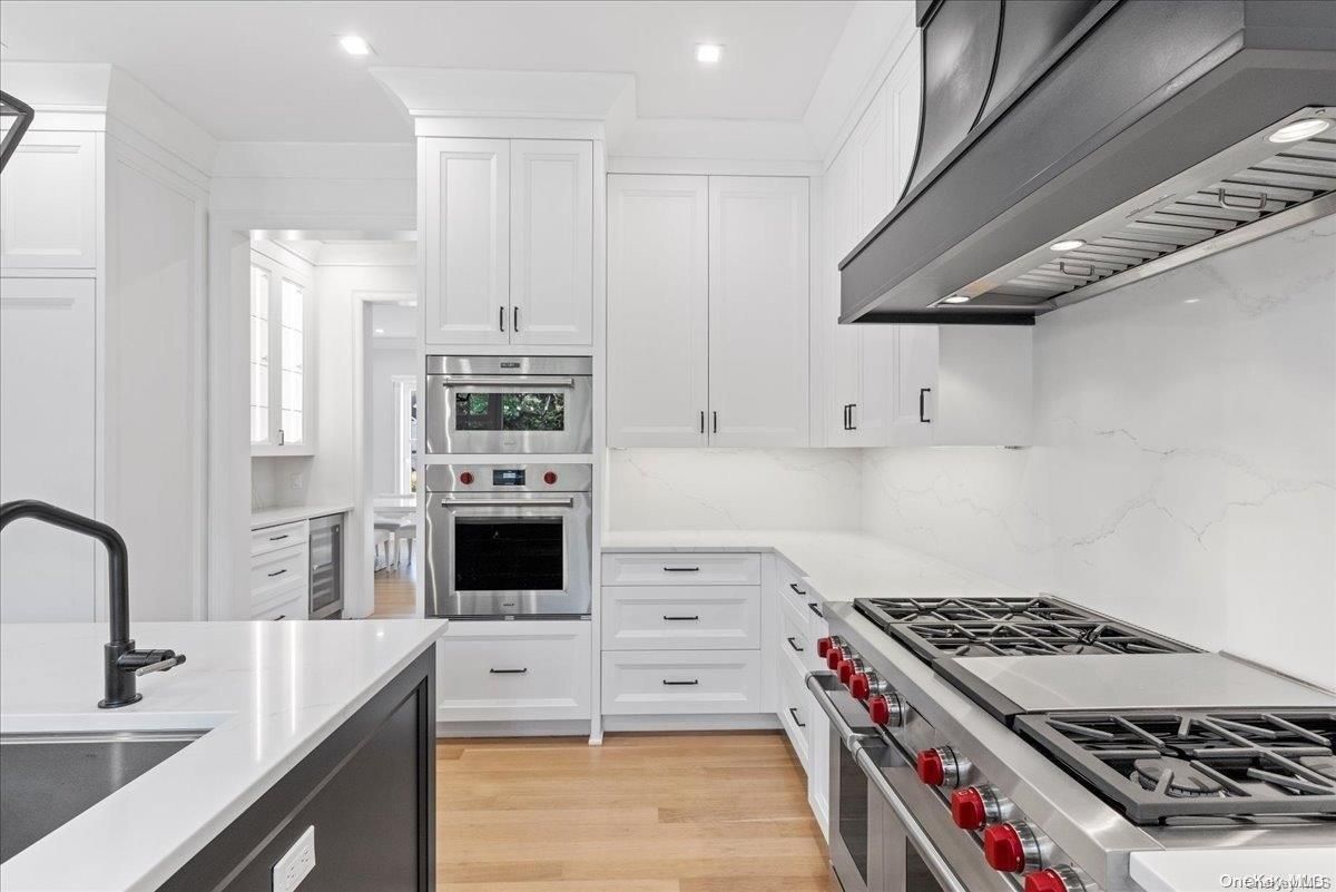 Interior, Kitchen, Marble Walls, Recessed Lighting, Stainless Steel Appliances, Wood Texture Flooring