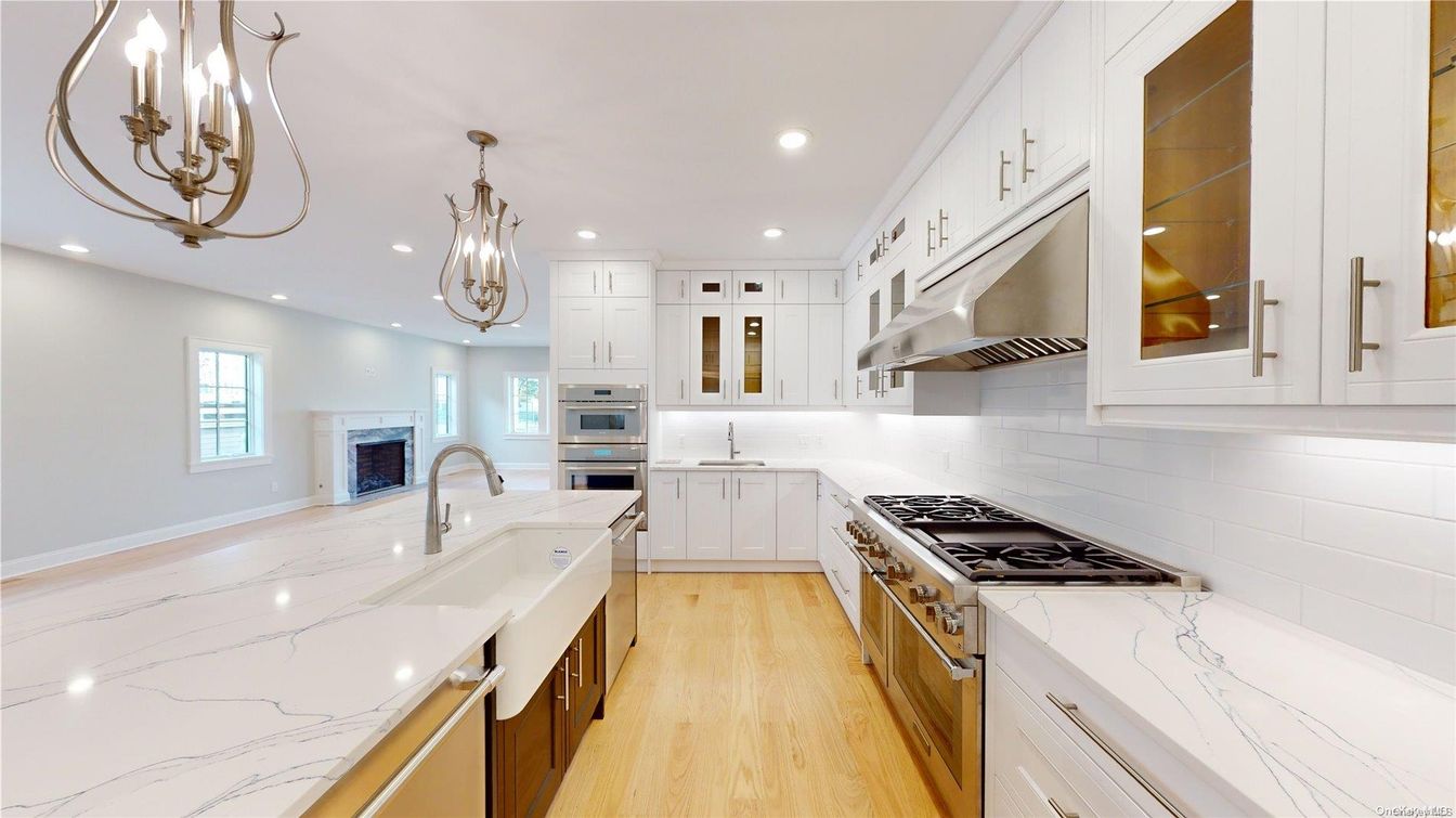 Chandelier, Fireplace, Interior, Kitchen, Recessed Lighting, Stainless Steel Appliances, Wood Texture Flooring