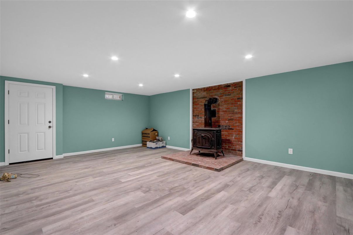 Empty room, Fireplace, Interior, Recessed Lighting, Stone Walls, Wood Texture Flooring