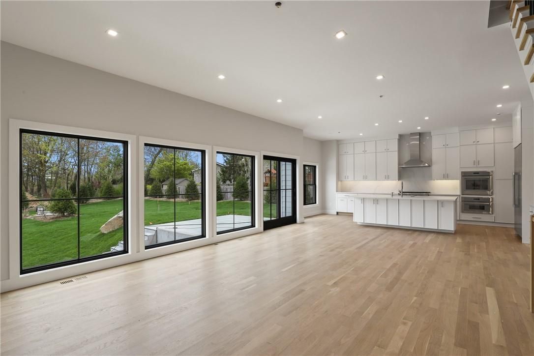 Empty room, Interior, Kitchen, Recessed Lighting, Stainless Steel Appliances, Wood Texture Flooring