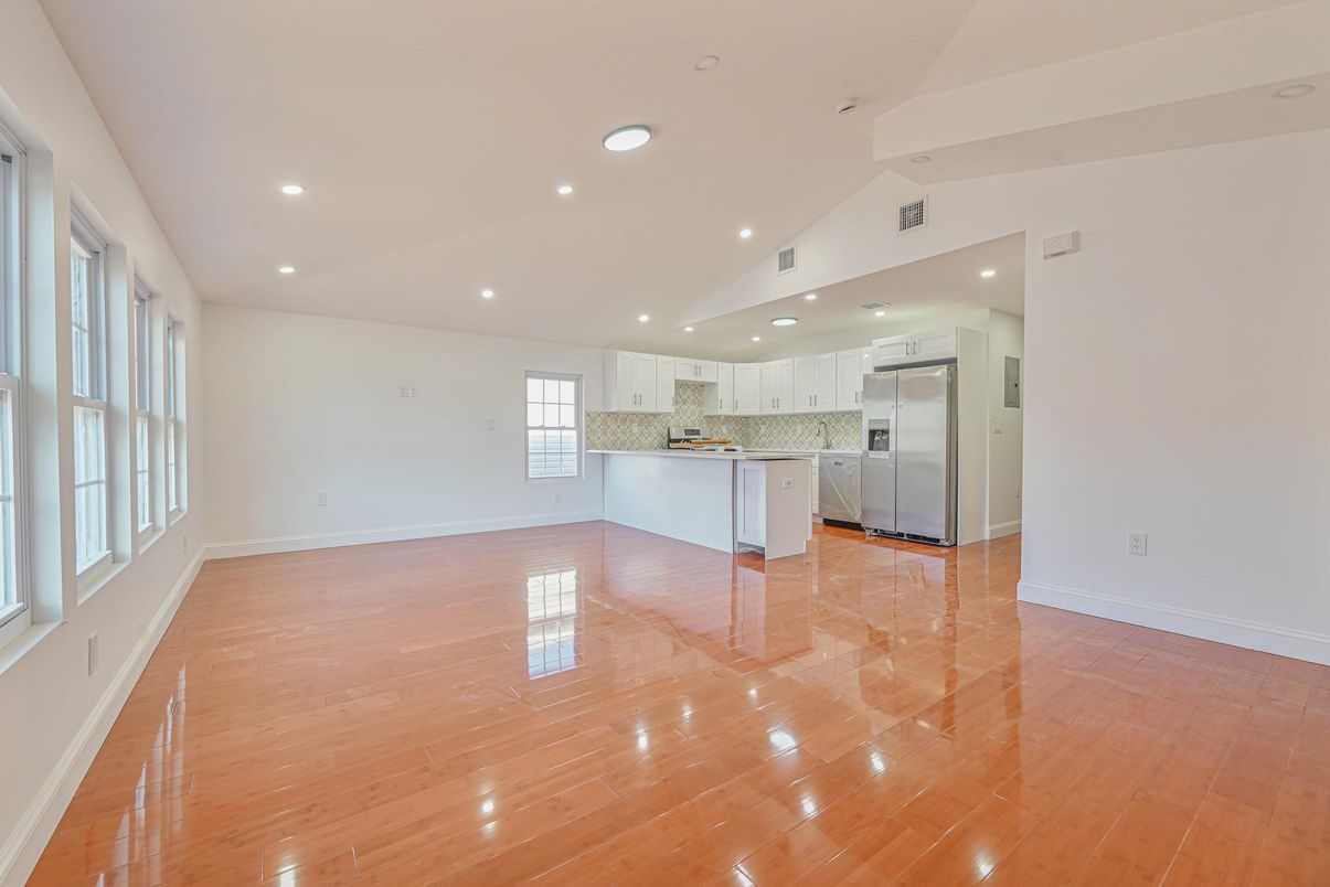 Empty room, Interior, Kitchen, Recessed Lighting, Stainless Steel Appliances, Wood Texture Flooring