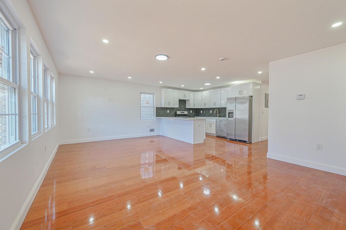 Empty room, Interior, Kitchen, Recessed Lighting, Stainless Steel Appliances, Wood Texture Flooring