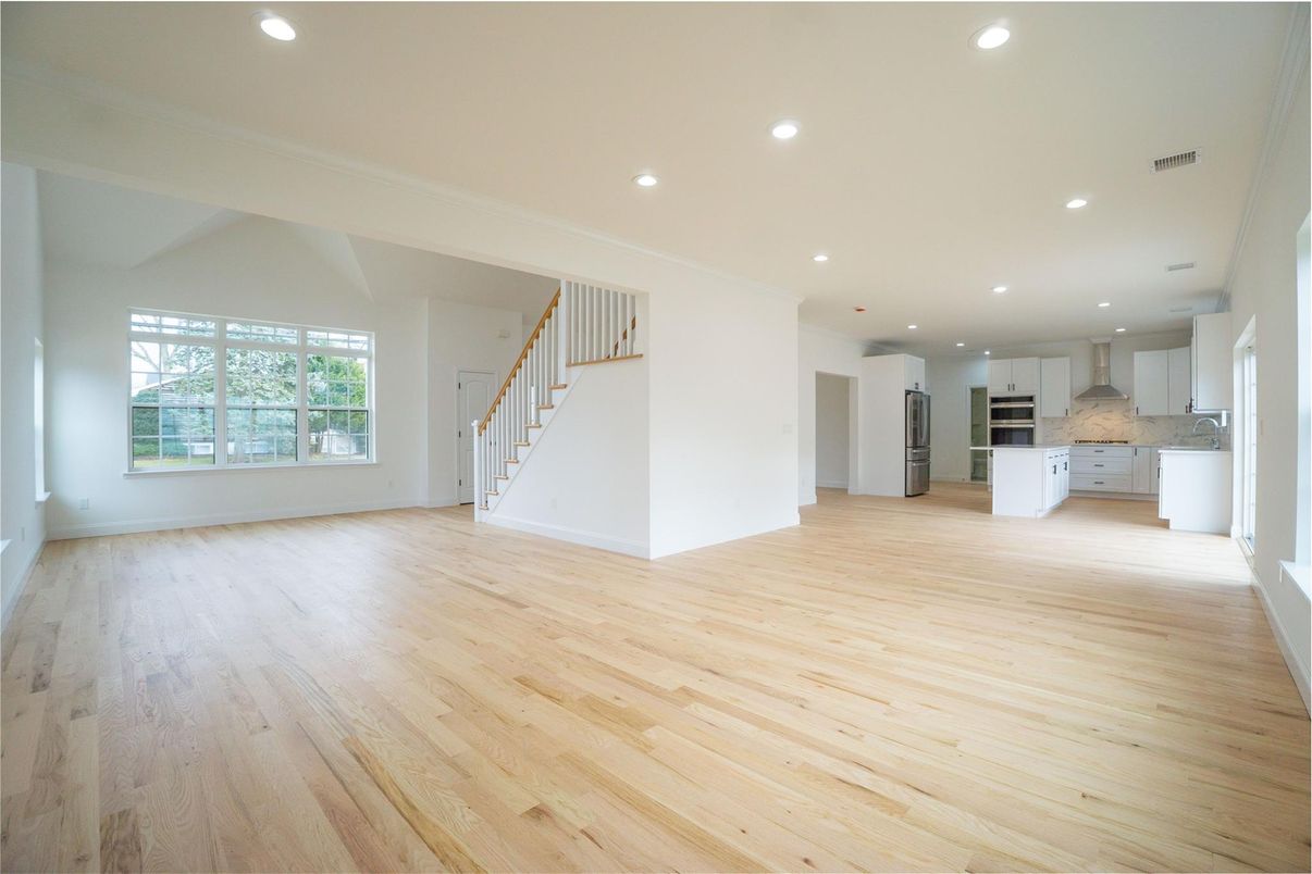 Empty room, Interior, Kitchen, Recessed Lighting, Stainless Steel Appliances, Wood Texture Flooring