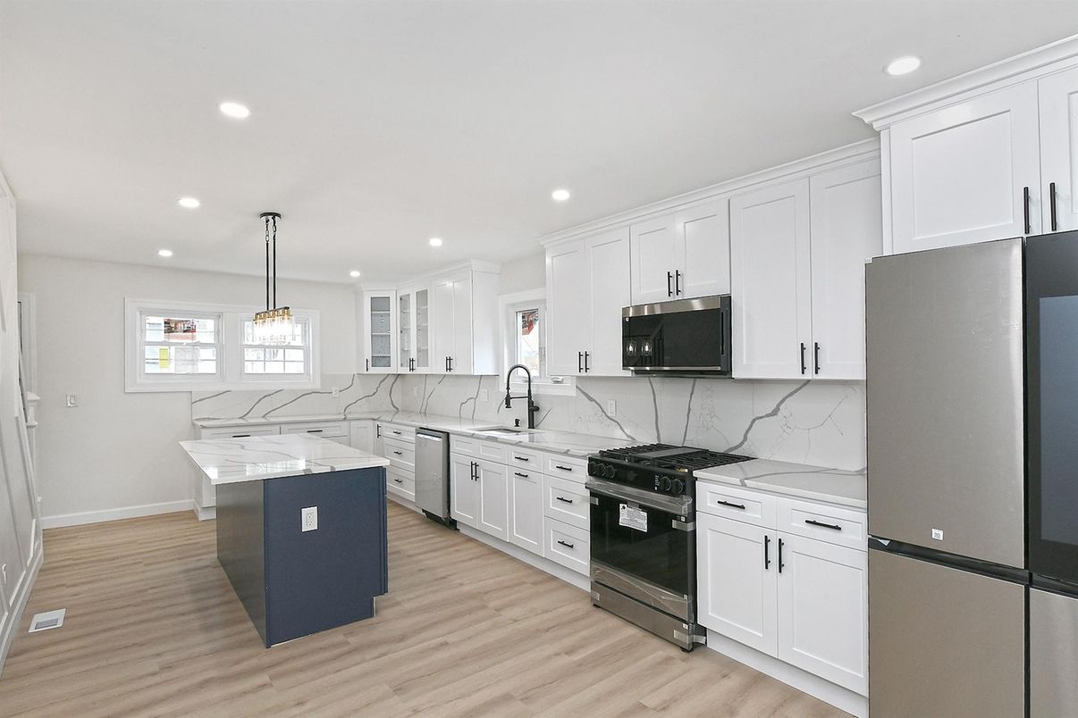 Interior, Kitchen, Marble Walls, Pendant Lights, Recessed Lighting, Stainless Steel Appliances, Wood Texture Flooring