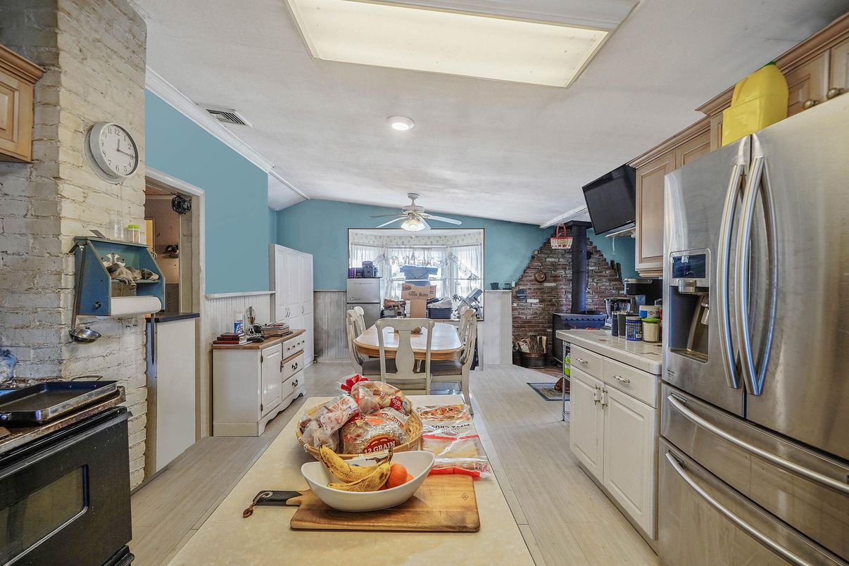 Dining room, Interior, Kitchen, Recessed Lighting, Stainless Steel Appliances, Stone Walls, Wood Texture Flooring
