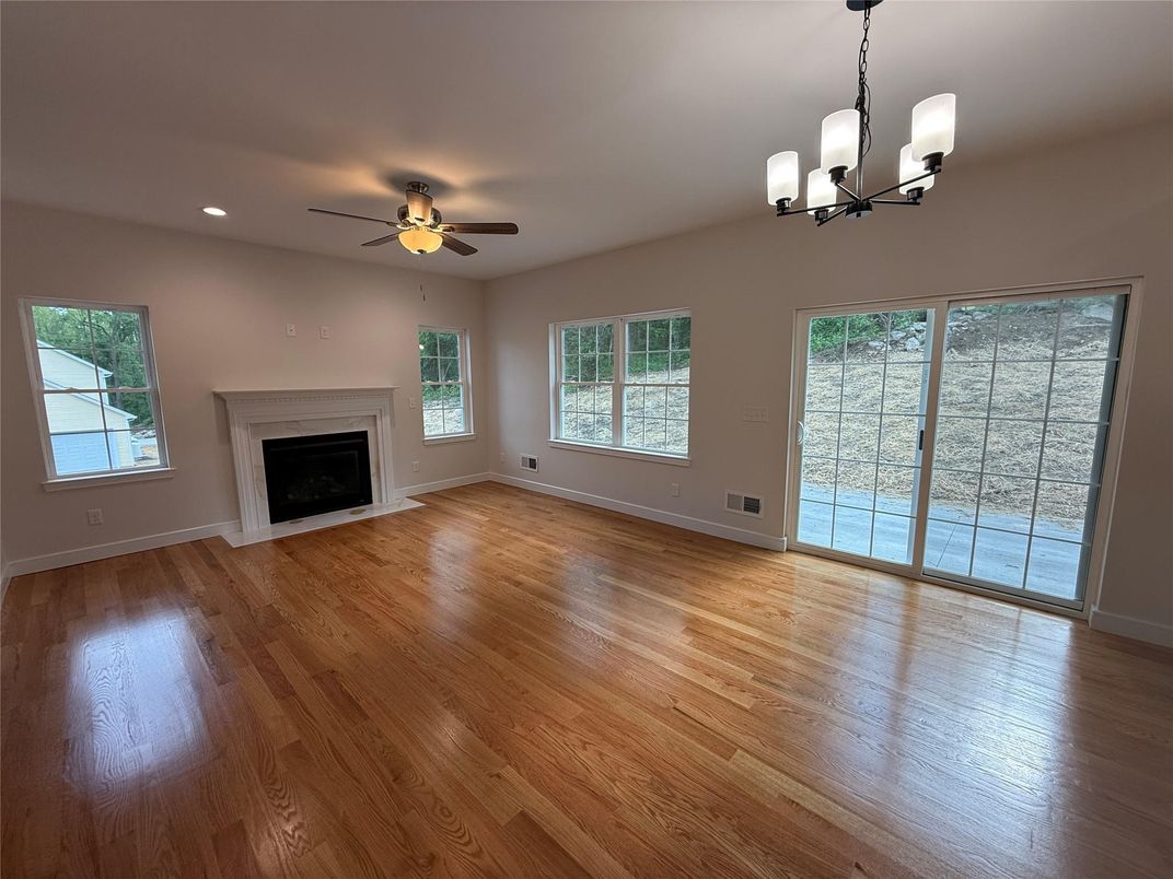 Chandelier, Empty room, Fireplace, Interior, Recessed Lighting, Wood Texture Flooring