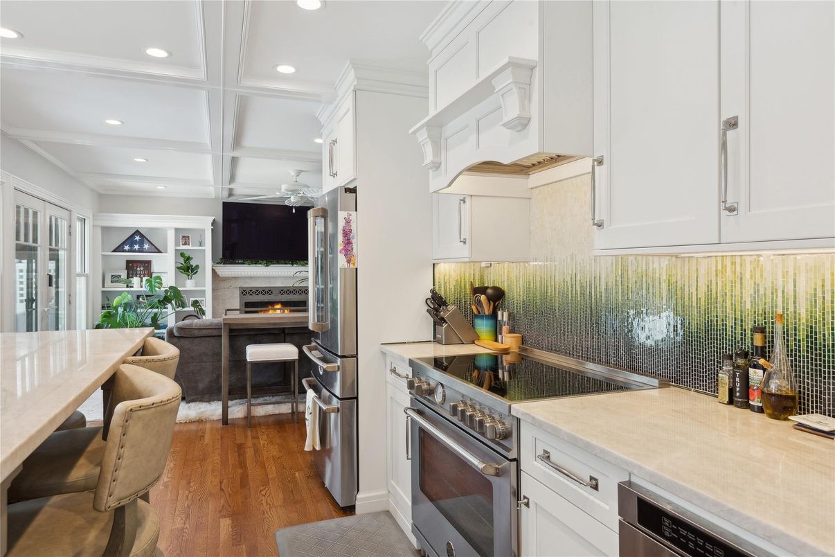 Dining room, Fireplace, Interior, Kitchen, Recessed Lighting, Stainless Steel Appliances, Wood Texture Flooring