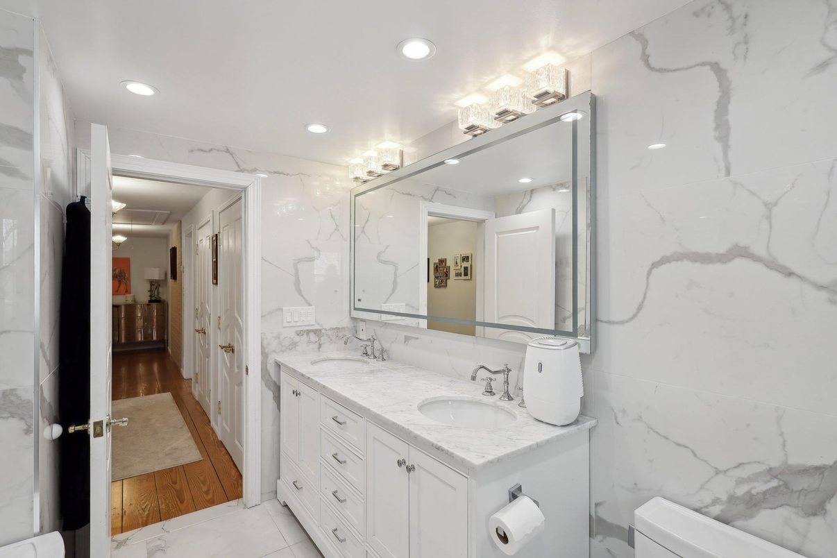 Bathroom, Dual Sink Vanities, Interior, Marble, Marble Walls, Recessed Lighting, Wood Texture Flooring