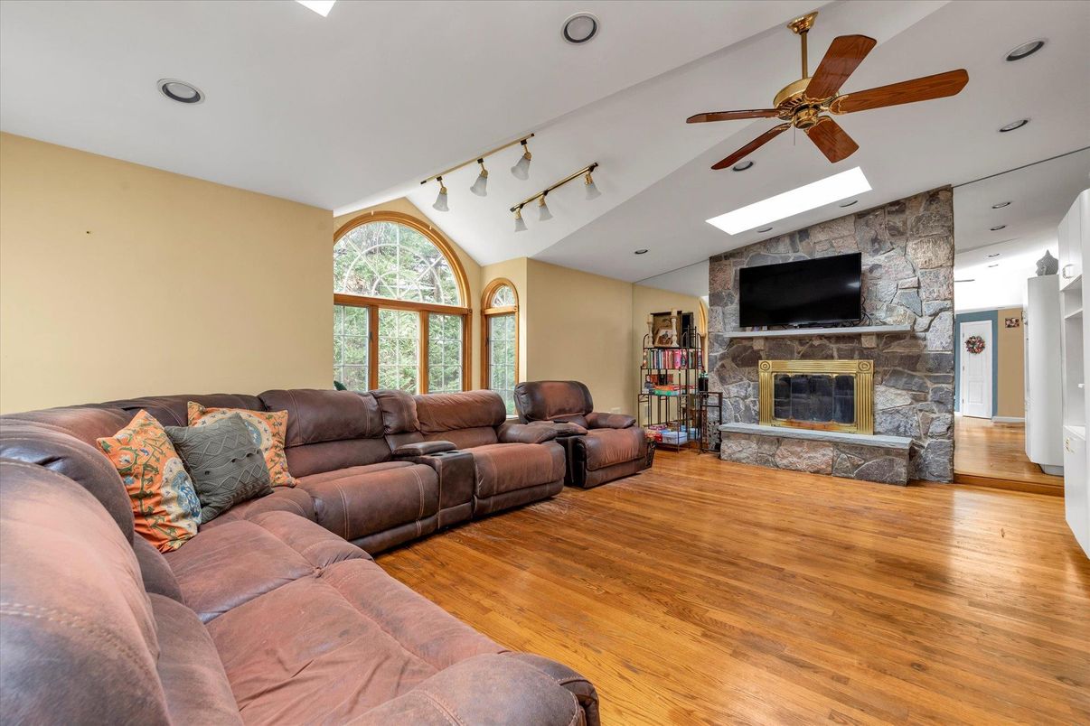 Fireplace, Interior, Living room, Recessed Lighting, Stone Walls, Wood Texture Flooring