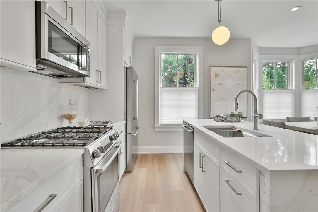 Interior, Kitchen, Marble Walls, Pendant Lights, Recessed Lighting, Stainless Steel Appliances, Wood Texture Flooring