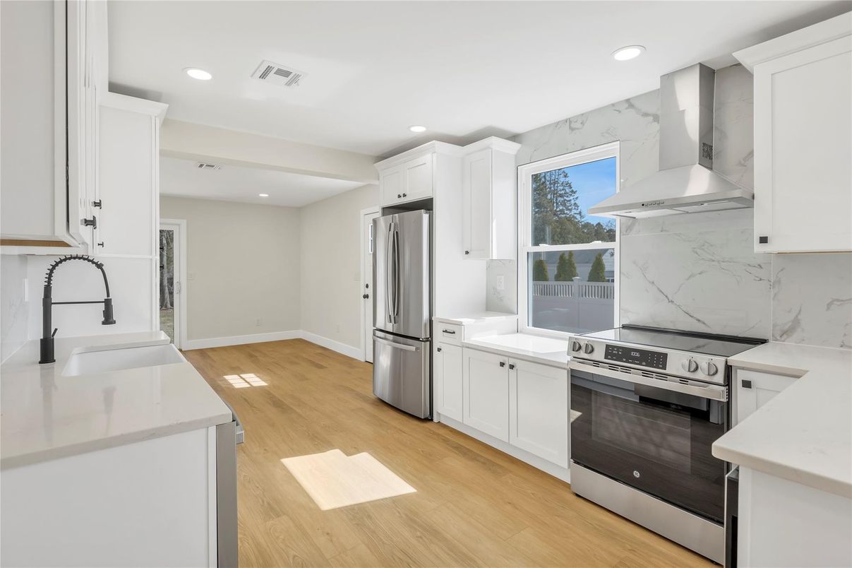 Interior, Kitchen, Marble Walls, Recessed Lighting, Stainless Steel Appliances, Wood Texture Flooring