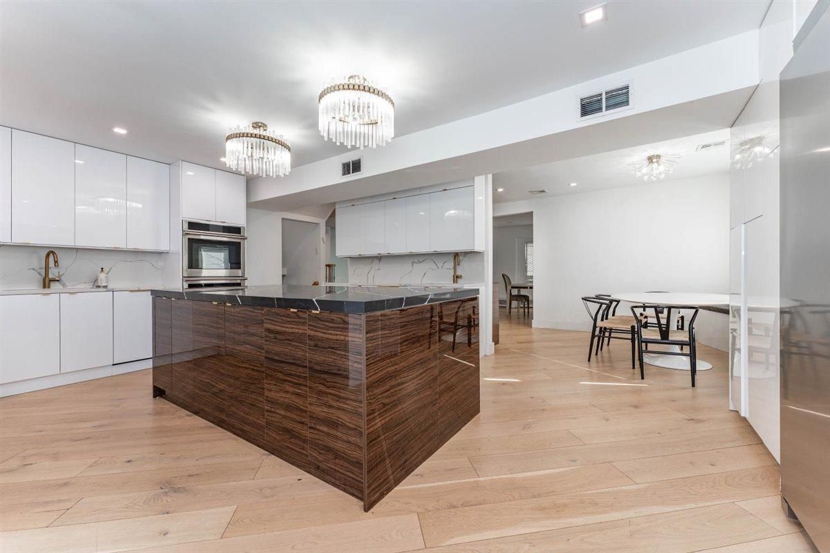 Chandelier, Dining room, Interior, Kitchen, Recessed Lighting, Stainless Steel Appliances, Wood Texture Flooring