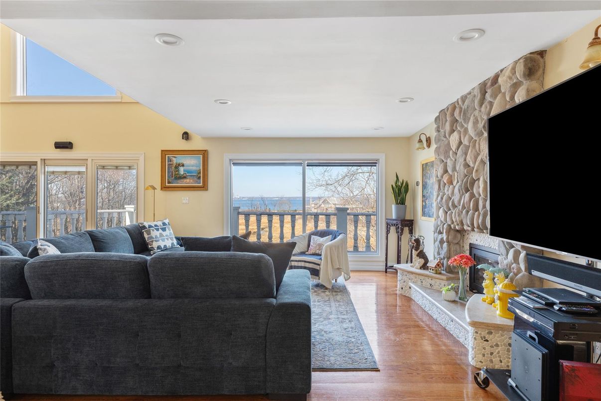 Fireplace, Interior, Living room, Recessed Lighting, Stone Walls, Wood Texture Flooring