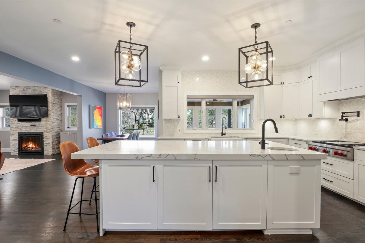 Dining room, Fireplace, Interior, Kitchen, Pendant Lights, Recessed Lighting, Stainless Steel Appliances, Stone Walls, Wood Texture Flooring