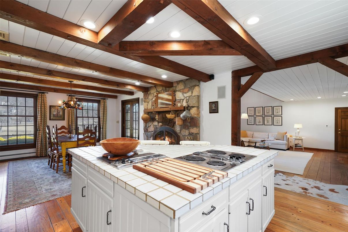 Chandelier, Dining room, Fireplace, Interior, Kitchen, Living room, Pendant Lights, Recessed Lighting, Tile Countertops, Wooden Beams, Wood Texture Flooring