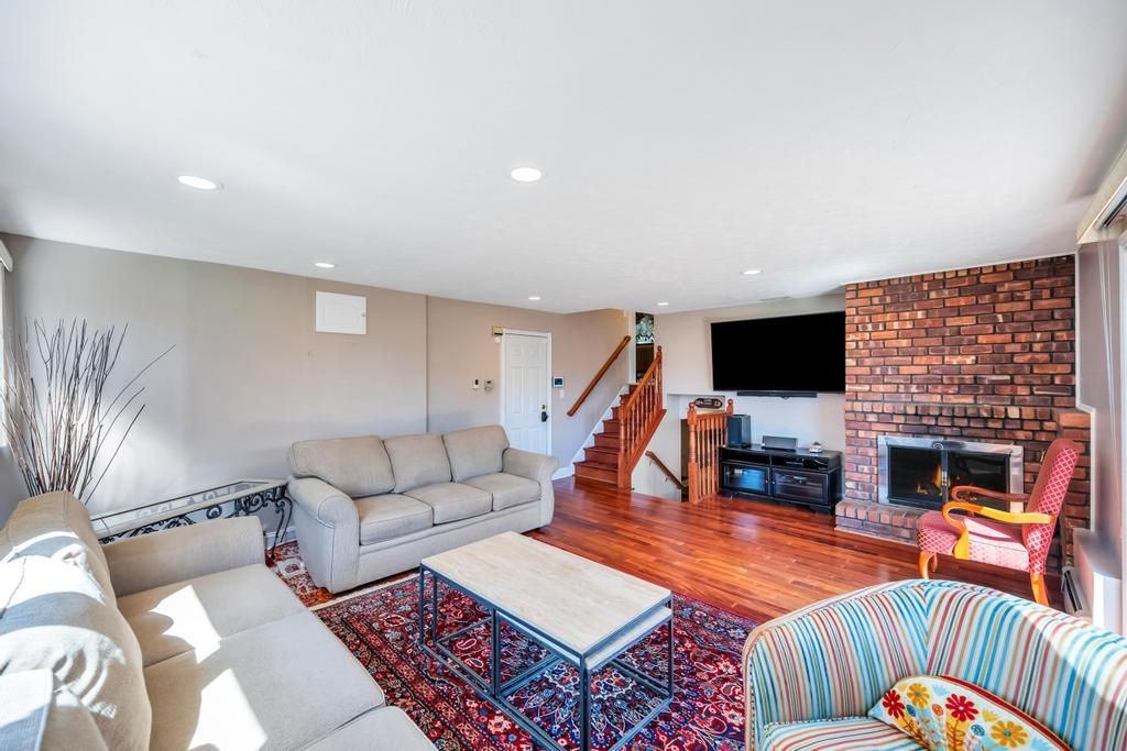 Fireplace, Interior, Living room, Recessed Lighting, Stone Walls, Wood Texture Flooring