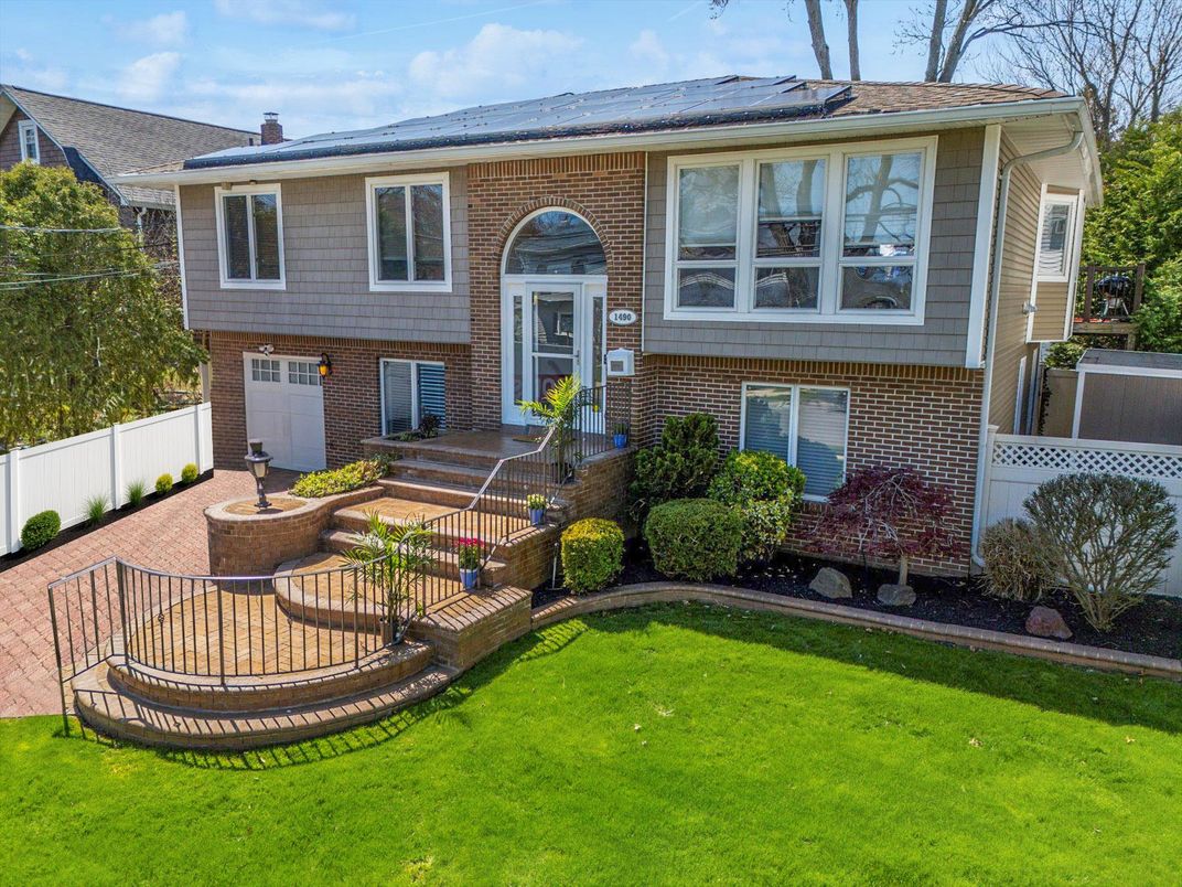 Attached, Exterior, Facade, Brick Facade, Solar Panels, Raised Ranch
